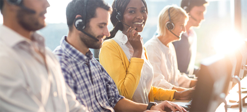 Team working with headsets and computers