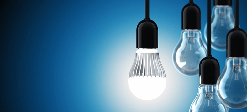 A lit up LED bulb in the middle with unlit bulbs on its right side.