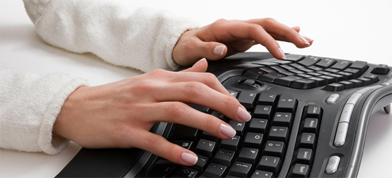 hands typing on a keyboard