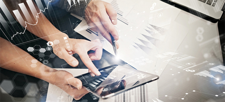 Hands holding a tablet and touching the screen with charts and financial figures in the foreground.