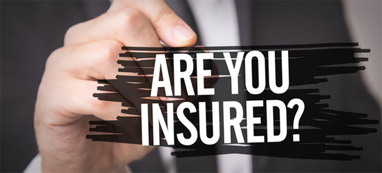 Man in a suit's hand with white capital bolded letters saying 'ARE YOU INSURED?'