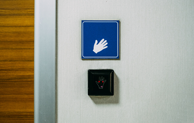 automatic hand switch with sensor with signage above indicating a hand swiping