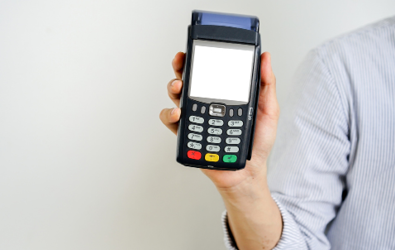 person holding up a wireless credit/debit processing device
