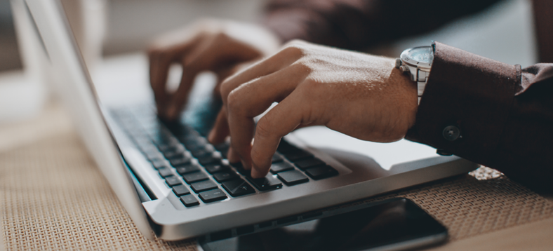 Webinar | Digitizing Information Management, hands typing on a laptop