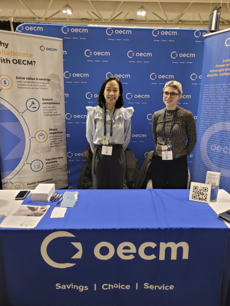OECM’s Business Analysts pose at the OECM exhibit booth at the Ontario Library Association Conference