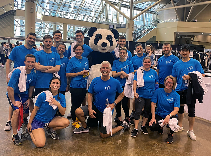 OECM staff standing with a Panda to raise funds for WWF at the CN Tower Climb