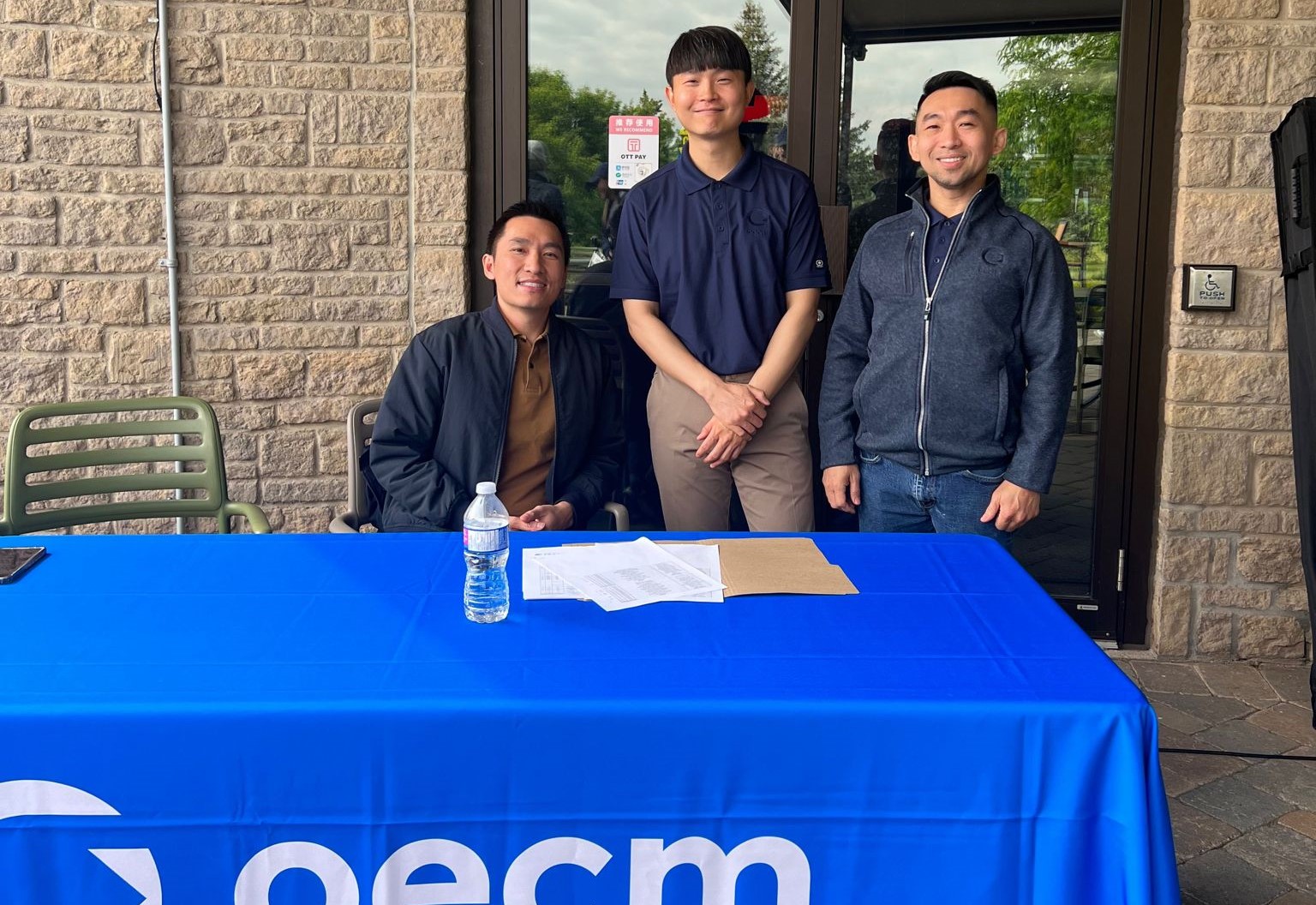 From Left, Curtis Diep, Justin Sin, and John See are waiting to register golfers at the registration table.