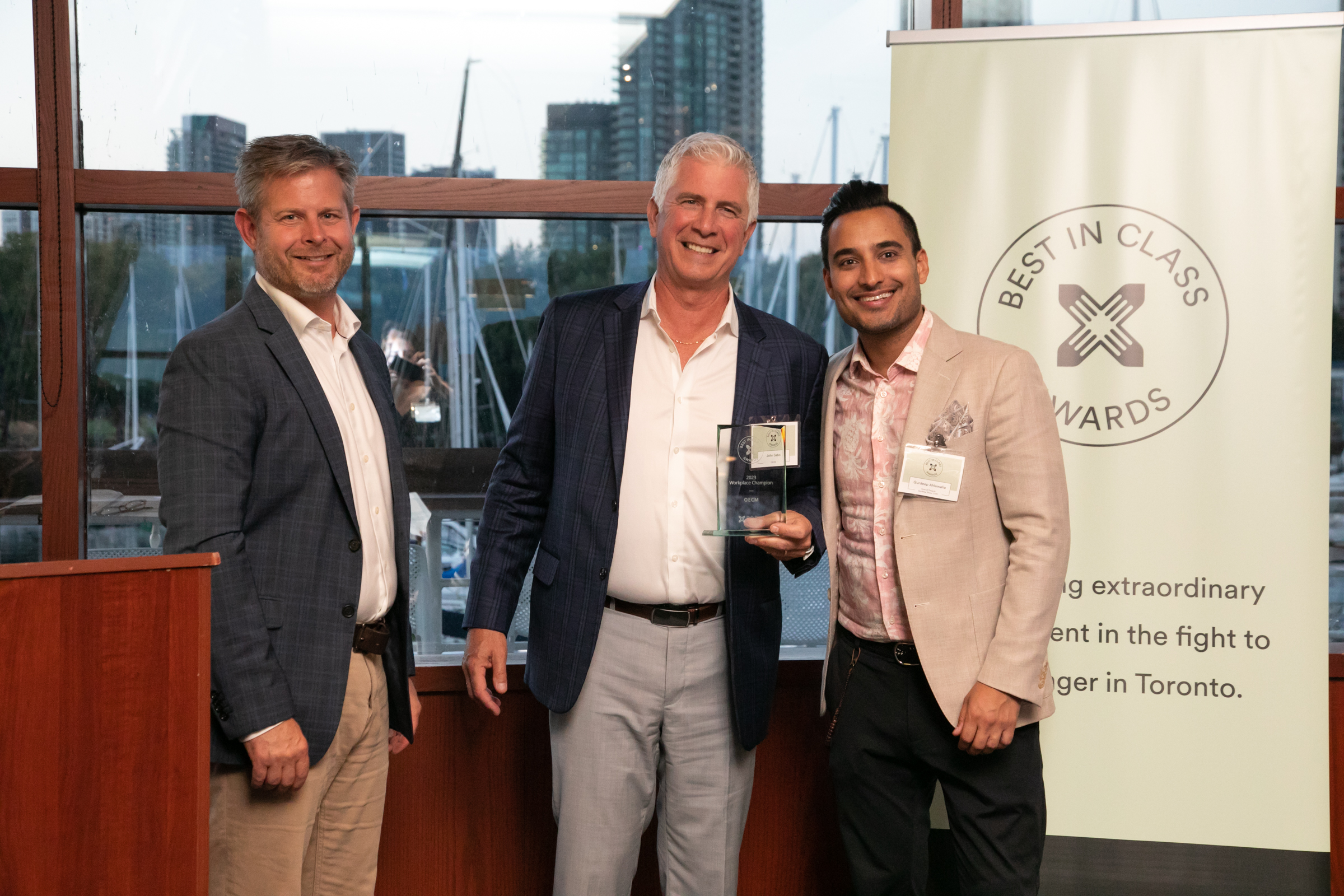 From left: Neil Hetherington, CEO of Daily Bread Food Bank, John Sabo, President and CEO of OECM, and event emcee and radio personality, Gurdeep Ahluwalia at Daily Bread's Best in Class Awards ceremony.