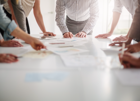 business people huddled around a board table