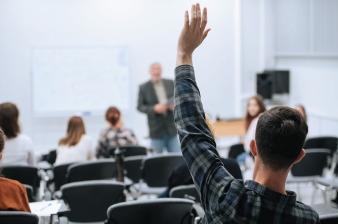 lecture room with person raising their hand