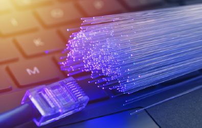 network category 5 and fibre optic cables resting on a computer keyboard