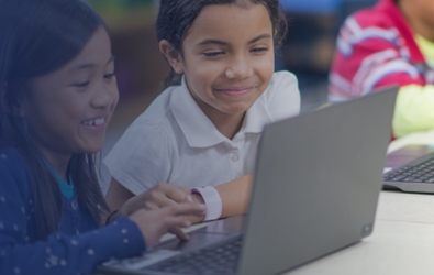 Two children looking at a laptop screen