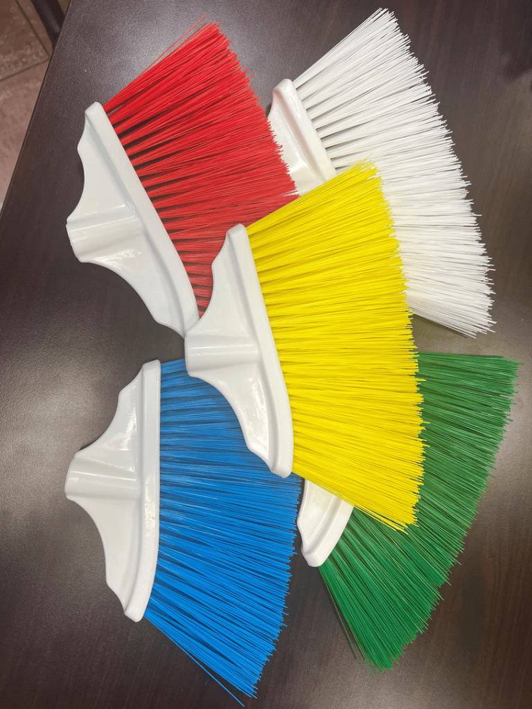 Colour-coded M2 Professional cleaning brooms in red, white, yellow, blue, and green