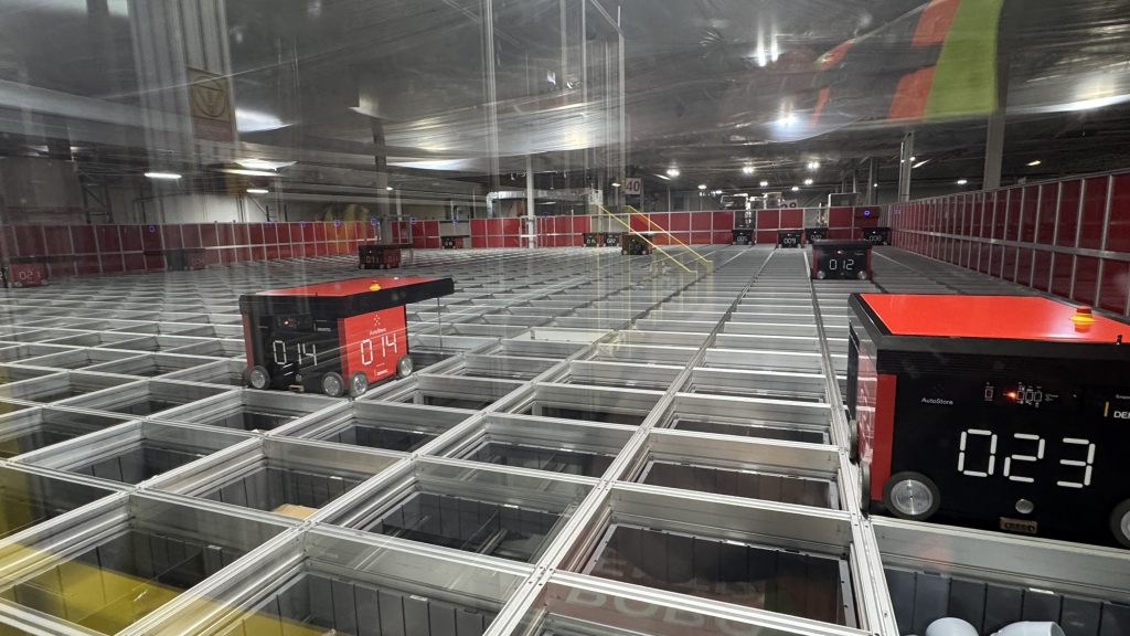 Robots move across Noble’s AutoStore grid to retrieve product bins for order fulfillment.
