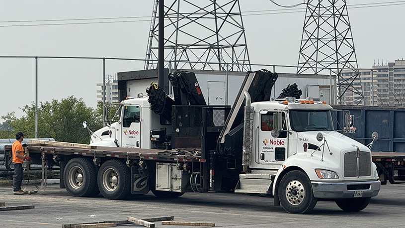 Noble boom trucks used to deliver and lift plumbing, HVAC and mechanical products at customer sites.