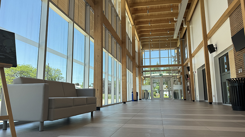 Town Hall atrium with public seating, exposed wood beams and floor-to-ceiling windows.